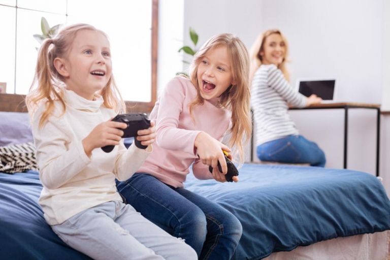 kids playing video games while mom working from home